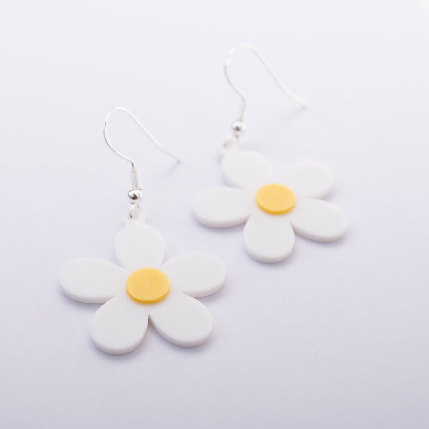 White daisy flower earrings with yellow center – 3D printed jewelry by Orla & Co