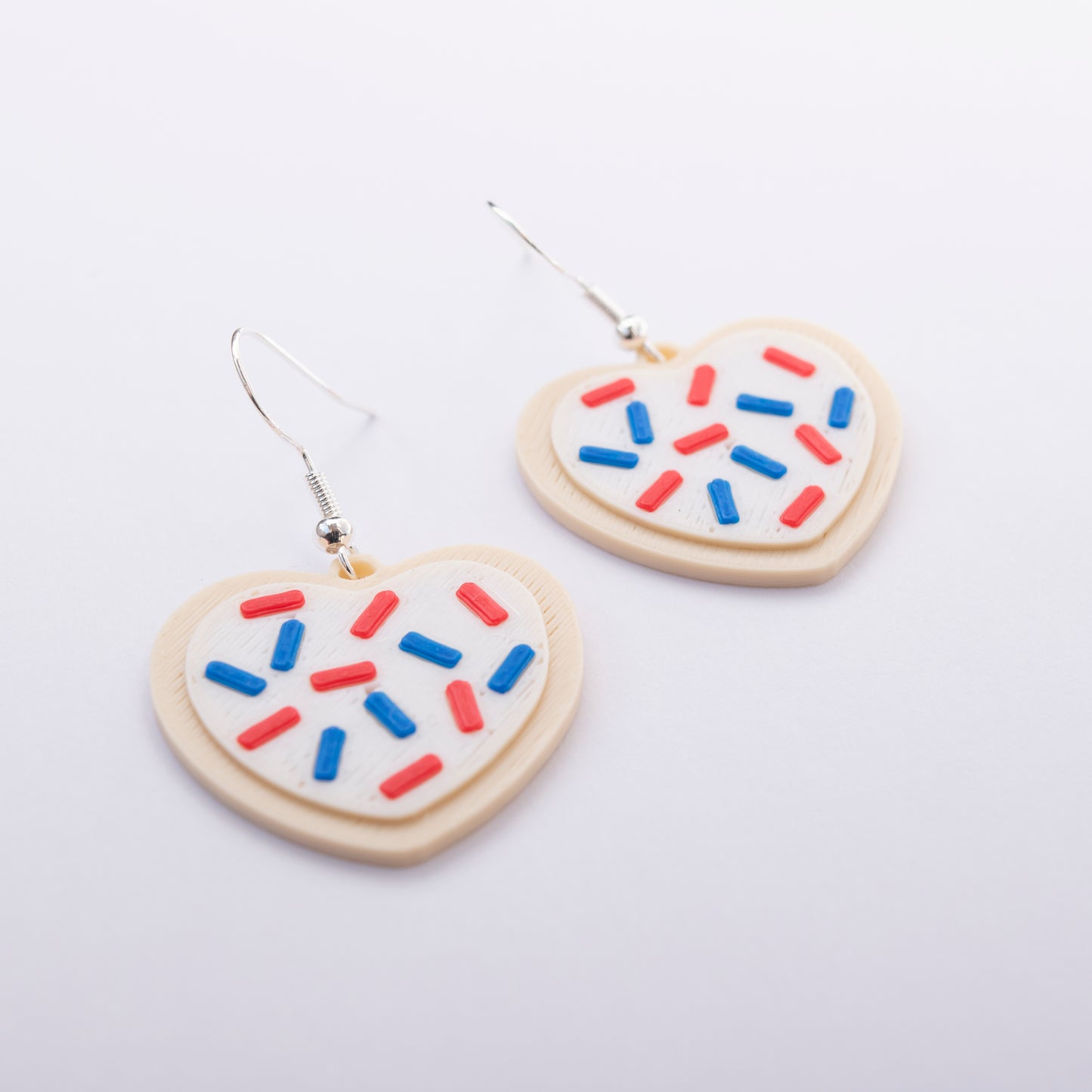 Red, white, and blue heart-shaped sugar cookie earrings โ patriotic jewelry by Orla & Co