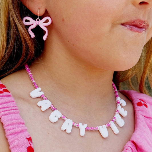 Girl wearing VACAY VIBES necklace with pink beads – Orla & Co personalized summer jewelry