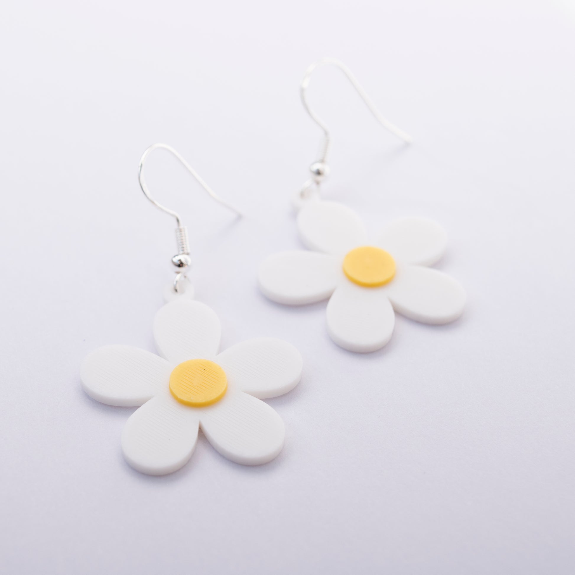 White daisy flower earrings with yellow center – 3D printed jewelry by Orla & Co